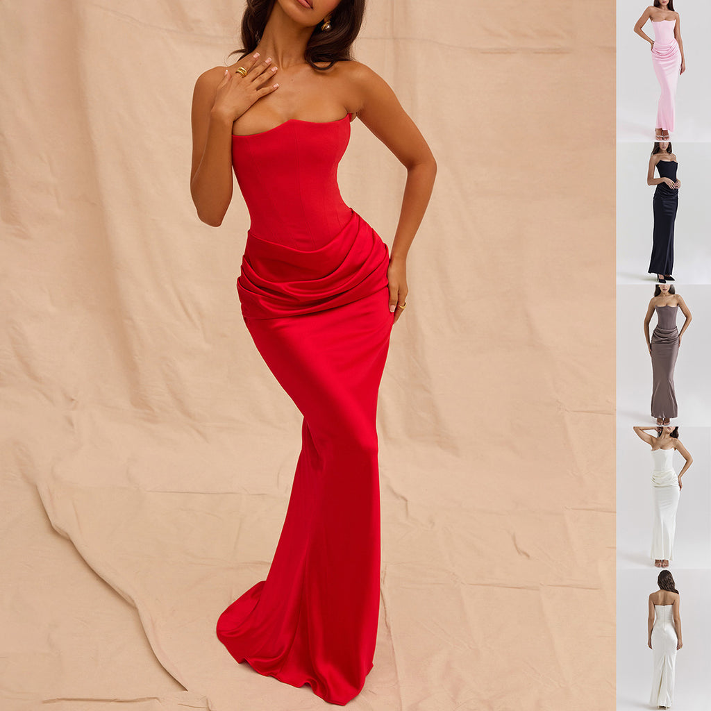 Woman wearing a strapless red evening gown on a beige background