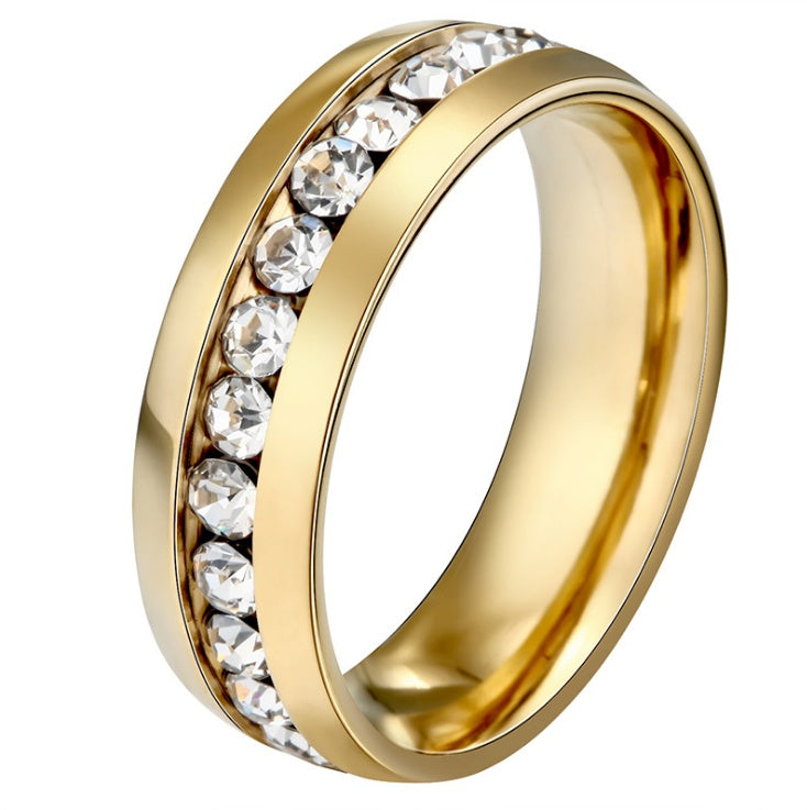Gold ring with embedded clear stones on a white background